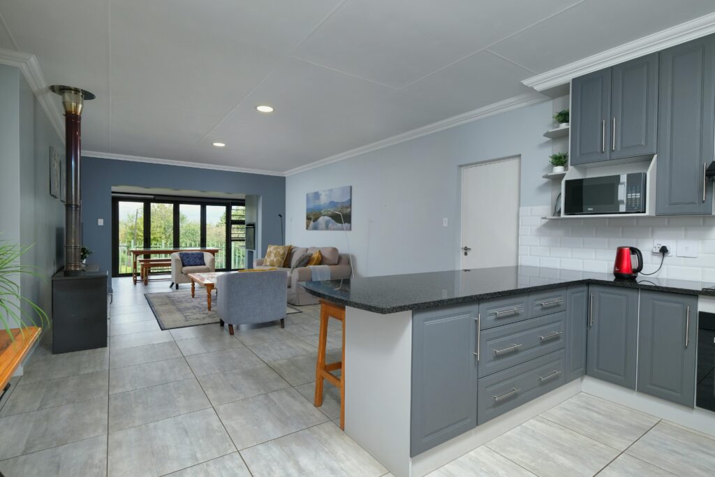 Spacious modern kitchen and living area with open floor plan and natural lighting.